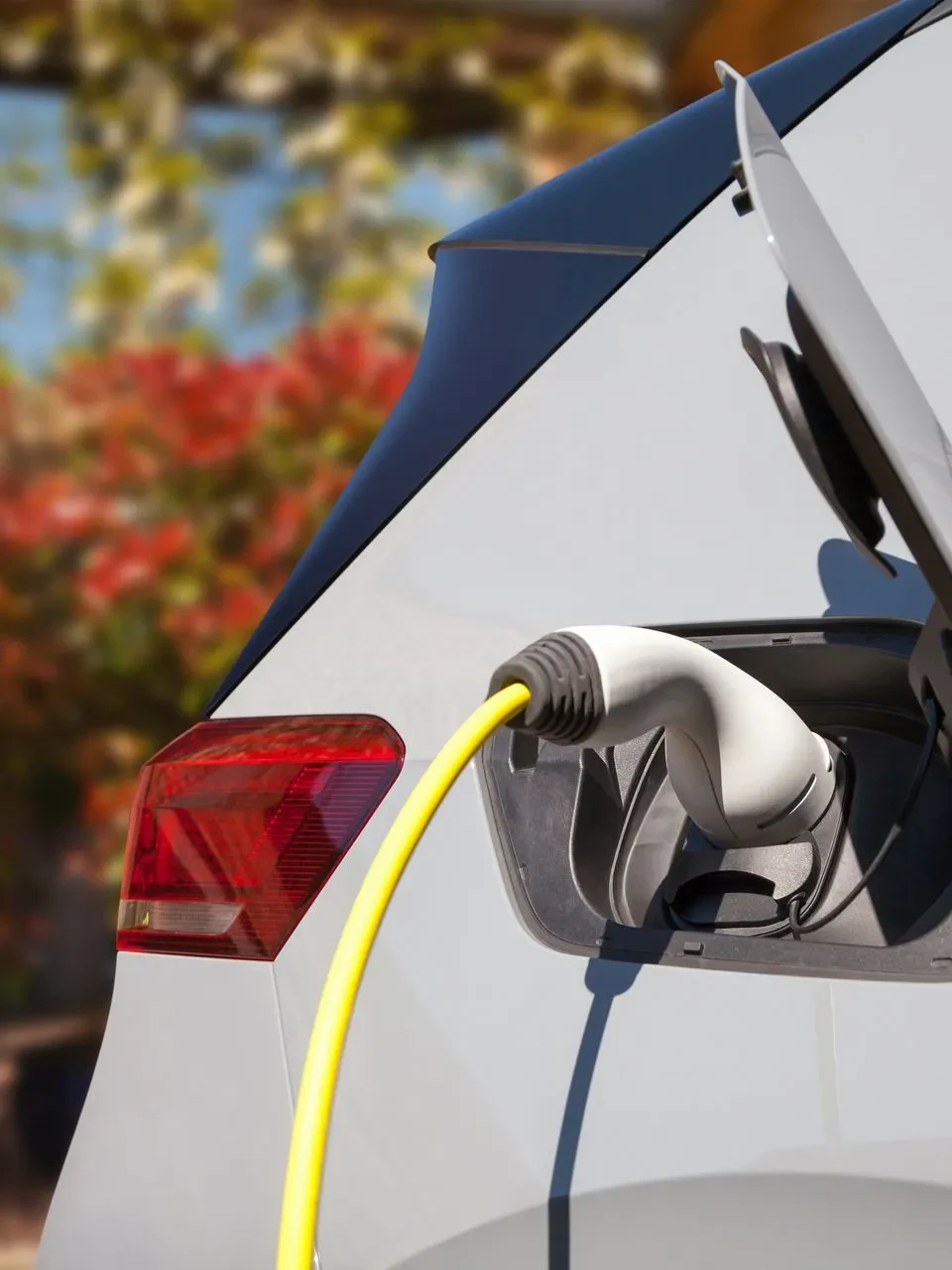 Scène extérieure urbaine avec véhicule électrique en charge sur pavés